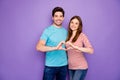 Photo of two charming people couple making hands fingers heart figure celebrating lovers day wear casual outfit t-shirts