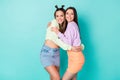 Photo of two charming sisters ladies friends youth look clothes outfit hugging glad to meet each other wear cropped