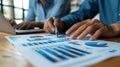Analyzing Market Data: Two Confident Businesspeople Pointing to Graphs and Charts to Plan New Sales Strategies and Increase Produc