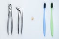 Photo of two dental tools with tooth on isolated white background Royalty Free Stock Photo