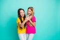 Photo of two encouraged funny nice cute girls people wearing t-shirts pink yellow watching some video on telephone while