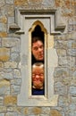 Prison cell faces looking through fort window Royalty Free Stock Photo