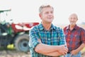 Cropped image of two farmers using digital tablet in field