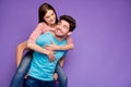 Photo of two funky carefree people guy carrying lady piggyback look eyes cheerful free time adventures wear casual Royalty Free Stock Photo