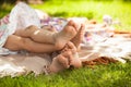 Photo of two girls feet lying on grass and having fun