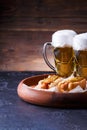 Photo of two glasses of beer and hot dogs on wooden tray Royalty Free Stock Photo