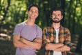 Photo of two guy friendship happy positive smile confident crossed hands trees woods forest hiking trip outdoors