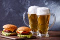 Photo of two hamburgers, glasses with beer Royalty Free Stock Photo