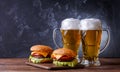 Photo of two hamburgers, glasses with beer Royalty Free Stock Photo