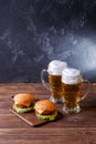 Photo of two hamburgers, glasses with beer Royalty Free Stock Photo