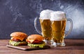 Photo of two hamburgers, glasses with beer Royalty Free Stock Photo