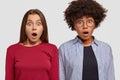 Photo of two impressed women recieve shocking news, keep jaw dropped from emotions, stare impressed at camera, open