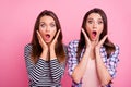 Photo of two impressed young ladies raise opened arms open mouth cant believe isolated on pink color background