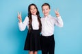 Photo of two little girl boy schoolkid best friends classmates cuddle show v-sign greeting teacher first school day wear