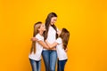 Photo of two little ladies hugging with pretty mommy wear casual outfit isolated yellow background