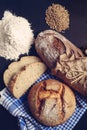 Photo of a two loaves of bread, some bread slices, flour and some wheat Royalty Free Stock Photo