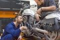 Photo of a two men in a motorcycle workshop. Royalty Free Stock Photo