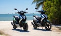 Photo of two motor scooters parked on a sandy beach