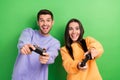 Photo of two overjoyed partners hands hold controller play video games isolated on green color background