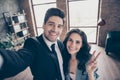 Photo of two partners making selfies in new workshop office showing v-sign dressed formal wear suits Royalty Free Stock Photo