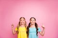 Photo of two people beautiful small ladies friends indicating fingers up empty space advising low sale shopping prices Royalty Free Stock Photo