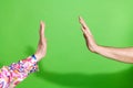 Photo of two people hands palms reaching touch each other giving high five green color background