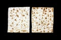 A photo of two pieces of matzah or matza isolated on black background. Matzah for the Jewish Passover holidays. Place for text, co