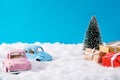 Photo of two pink blue small cars gifts transportation service present boxes near pine tree cute automobile couple