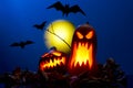 Photo of two pumpkins with burning mouths, bats at night Royalty Free Stock Photo
