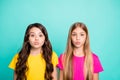 Photo of two small girlfriends with their lips pouted plumping you while isolated with teal background Royalty Free Stock Photo