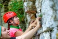 Photo of two sports women climbing up mountain