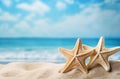 Photo of two starfish on a sandy beach with the ocean in the background Royalty Free Stock Photo