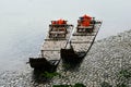 Two traditional Chinese style bamboo rafts moored on the shore