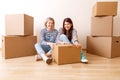 Photo of two women among cardboard boxes