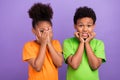 Photo of two young little afro kids worried scared horrified bite fingers close face isolated over violet color