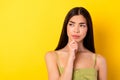 Photo of uncertain pretty young lady wear green outfit arm chin looking empty space isolated yellow color background Royalty Free Stock Photo