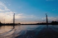 photo of an unconnected bridge with a sunset and river in the background