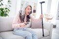 Photo of unhappy angry old woman hold hand cane stick switch channel scream tv indoors inside house home