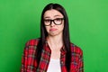 Photo of unhappy doubtful young woman wear glasses puzzled question isolated on green color background Royalty Free Stock Photo