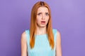 Photo of unhappy upset astonished amazed young woman problem bad mood isolated on purple color background