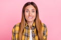 Photo of unhappy upset young woman bite lips teeth dilemma puzzled doubt isolated on pastel pink color background