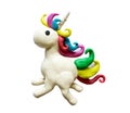 Photo of a unicorn made of clay. Unicorn plasticine. Plasticine unicorn molded by a child and isolated on a white background