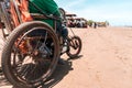 Photo of an unrecognizable disabled senior security guard seen from behind while patrolling the beach in Masachapa