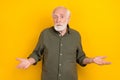 Photo of unsure aged grey hairdo man shrug shoulders wear khaki outfit isolated on yellow color background