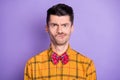 Photo of unsure doubtful young man wear plaid shirt bow tie mouth side isolated violet color background
