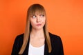 Photo of unsure nice blond hair lady look empty space wear black jacket isolated on bright orange color background