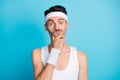 Photo of unsure sportive guy touch hand chin doubt crossfit regime wear white tank-top singlet isolated over blue color