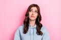 Photo of unsure suspicious girl dressed grey sweatshirt looking empty space pink color background