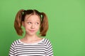 Photo of unsure tails hairdo little girl look empty space wear striped sweater isolated on green color background