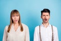 Photo of unsure upset young couple wear white outfit open mouth isolated blue color background